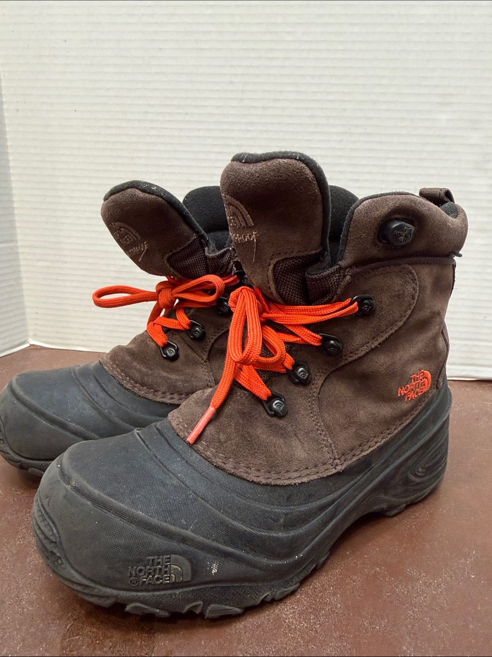 The North Face Kids Brown and Black Winter Boots with Orange Laces